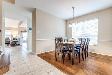 Dining space with chair railing.  Large window for
