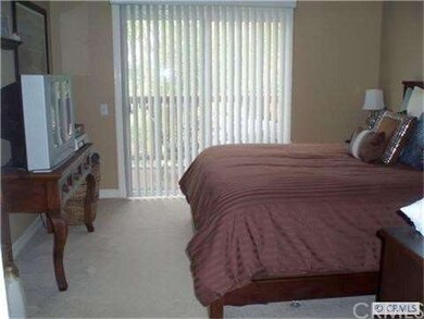 Spacious bedroom with sliding glass door leads out