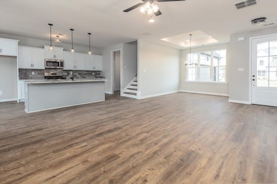 Unfurnished living room with visible vents, dark w