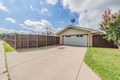 View of home's exterior featuring a garage and a l