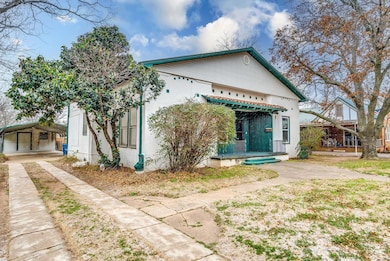 View of front of home featuring a carport, covered