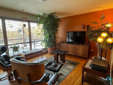 Living room featuring a textured ceiling and hardwood / wood-style flooring