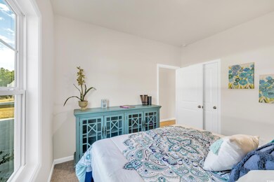 Carpeted bedroom with baseboards