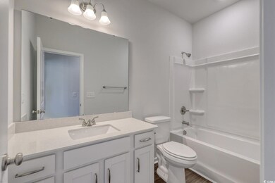 Bathroom with toilet, wood finished floors, vanity