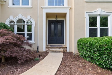 Property entrance featuring stucco siding