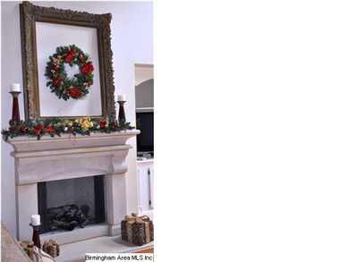Living room features a limestone fireplace with ga