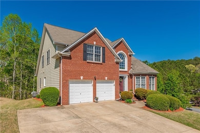 Traditional home featuring an attached garage, con