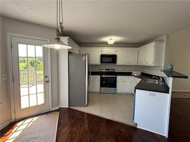 Kitchen with tasteful backsplash, dark countertops