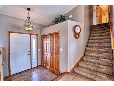 Ceramic Tiled Foyer. 6-panel solid oak closet door