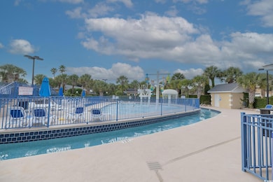 Community pool featuring a patio area