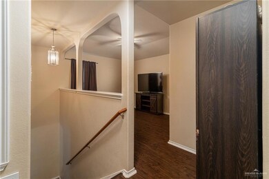 Hallway featuring an upstairs landing and dark wood-style flooring