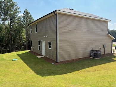 View of home's exterior featuring a yard and a central air condition unit