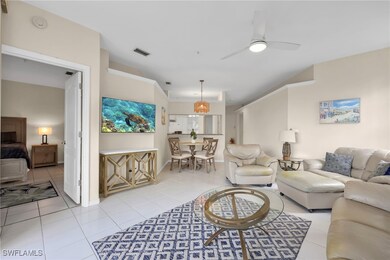 Living room with light tile patterned floors and a