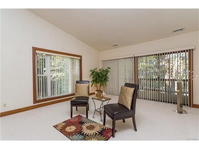 LARGE LIVING ROOM WITH DOORS TO A COVERED PORCH