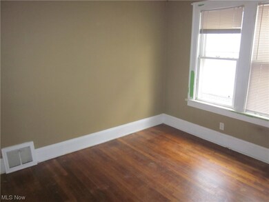 Empty room featuring dark hardwood / wood-style floors