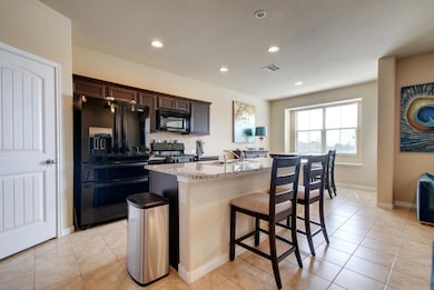 Kitchen featuring an island with sink, visible ve