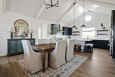 Dining area & great room with vaulted ceiling and optional white-painted ceiling beams