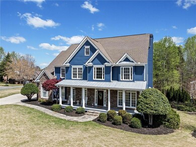 View of front of home featuring a front lawn, a po