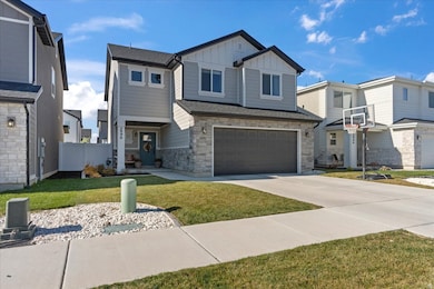 Craftsman-style house with board and batten siding, stone siding, concrete driveway, an attached garage, and a residential view