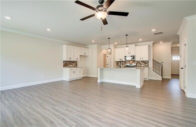 Unfurnished living room with baseboards, visible v