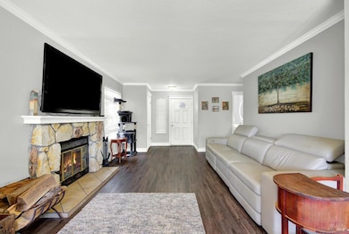 The home has a formal combination living an dining room for greeting guests and entertaining.  A fireplace with mantle centers the room.