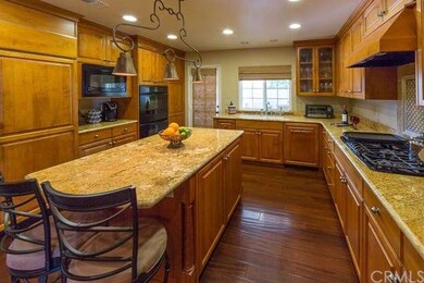 Granite counters in this gourmet kitchen. Cabinets