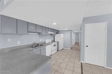 Kitchen with light tile patterned flooring, white