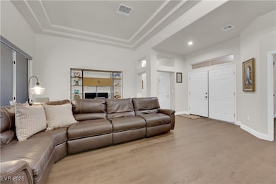Living room with wood finished floors, recessed li