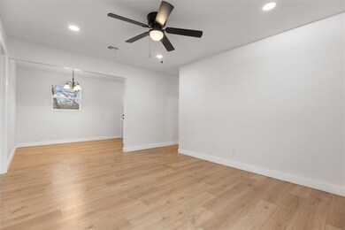 Spare room featuring light wood-style floors, visi