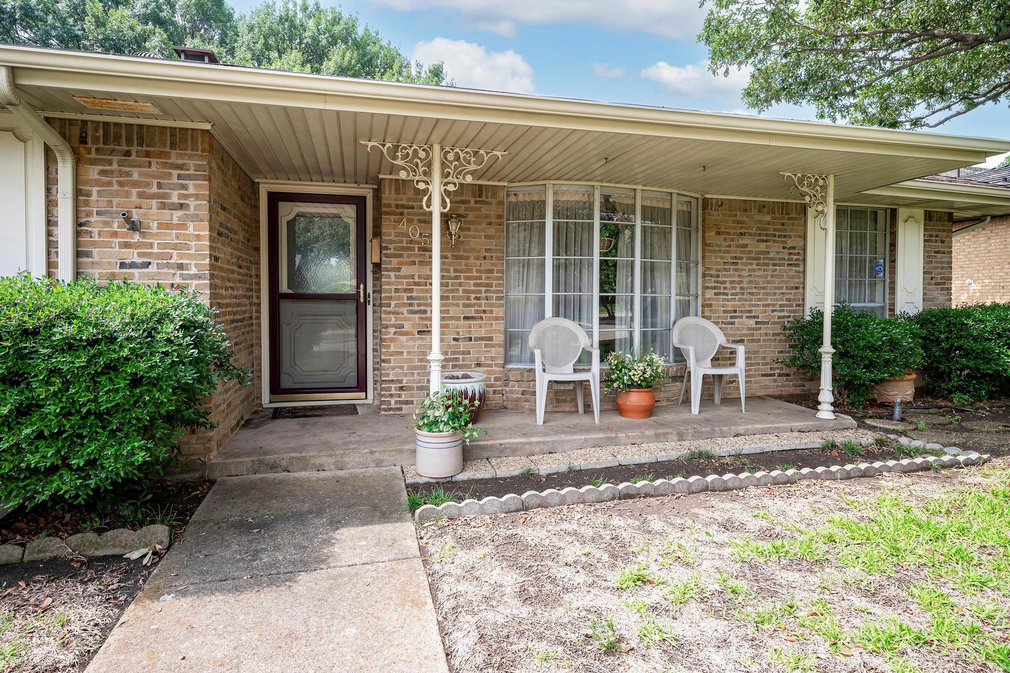 View of exterior entry with covered porch