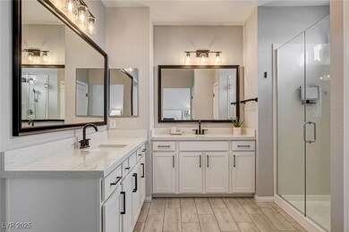 Bathroom with two vanities, a shower stall, and wo