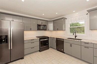 GORGEOUS CUSTOM CABINETS, BLACK STAINLESS APPLIANCES MAKE THIS KITCHEN A DREAM
