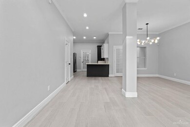 Unfurnished living room with recessed lighting, light wood-style floors, crown molding, and a chandelier