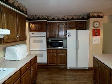 Kitchen. A built in oven, side by side refrigerato