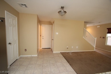 Empty room featuring stairway and baseboards