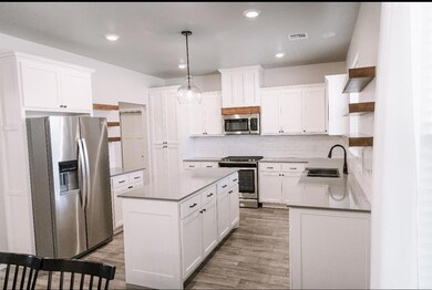 Kitchen with visible vents, a sink, a kitchen isla