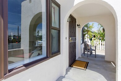 Arched entry with room on the front porch for a ta