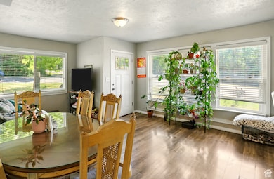Dining space featuring a textured ceiling and wood finished floors