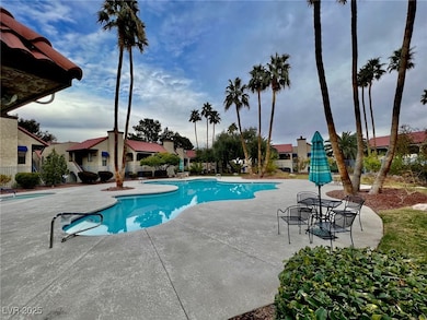Community pool with a patio