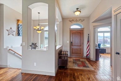 Foyer featuring wood-type flooring and a chandelier