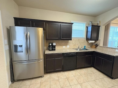 Kitchen featuring stainless steel fridge, dishwas