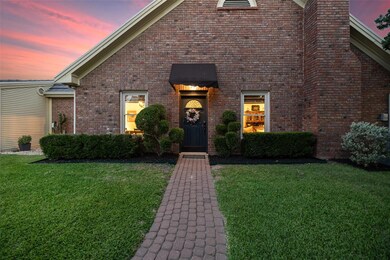 View of front of property with a front yard, bric