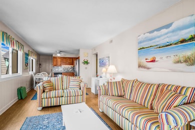 Living room with light wood-type flooring and a ceiling fan