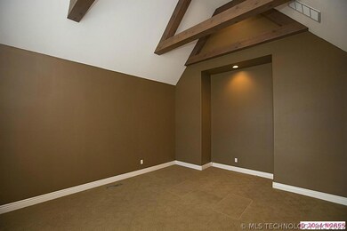 Living Room off entry has vaulted beamed ceiling.
