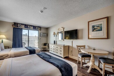 Bedroom featuring multiple windows, a textured cei