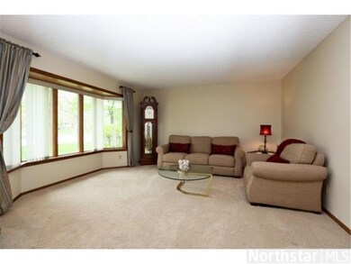 Open and inviting living room has newer carpet, pa