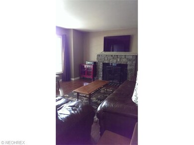 Pergo flooring and a wood burning fireplace make t