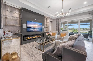 Living area featuring a raised ceiling, visible ve