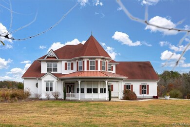 Victorian house with a front yard and a porch