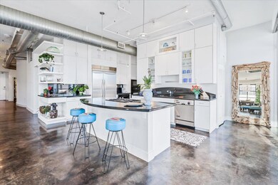 Kitchen with open shelves, dark countertops, conc